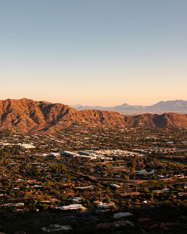 Aerial view of Scottsdale with Camelback Mountain at golden hour
