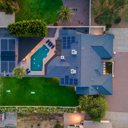 Aerial view of property with pool and pickleball court