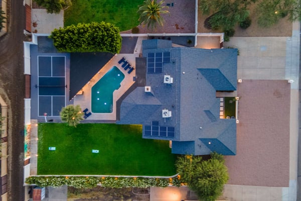 Aerial view of property with pool and pickleball court