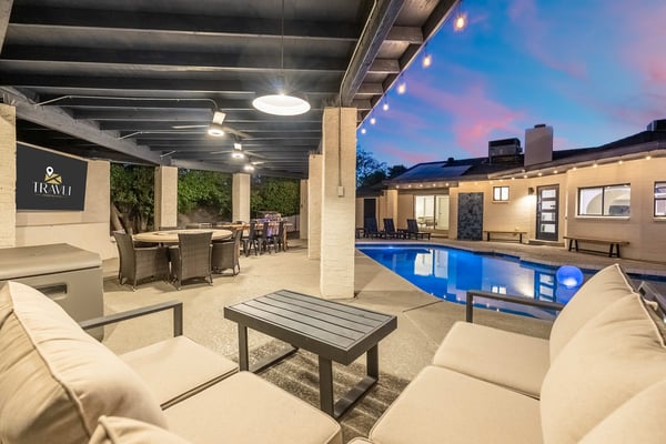 Covered patio with pool at dusk